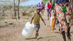A child in Kenya carries a jerry bucket for safe water storage.